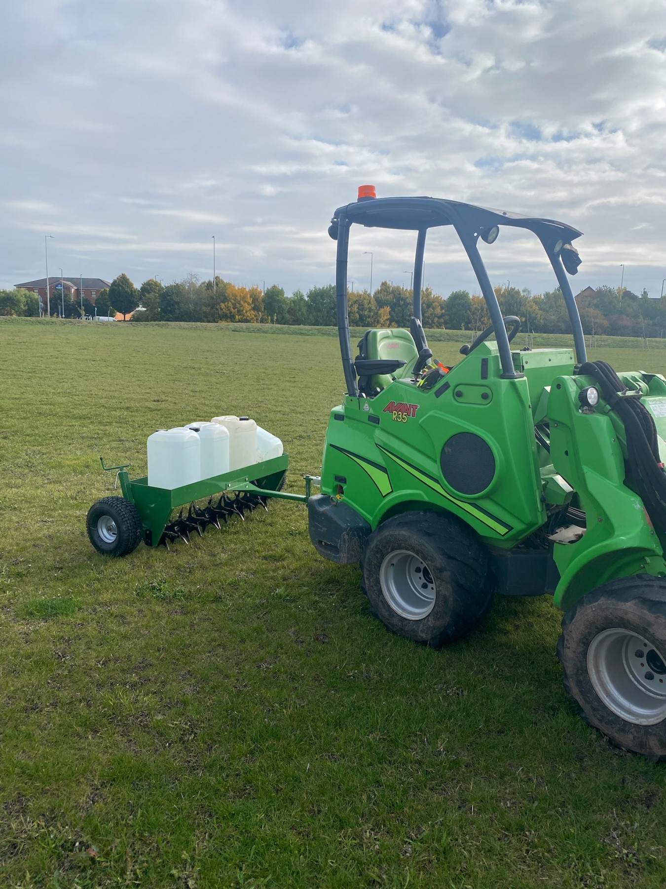 Landywood's Avant loader with a fertiliser spreader on a large commercial site