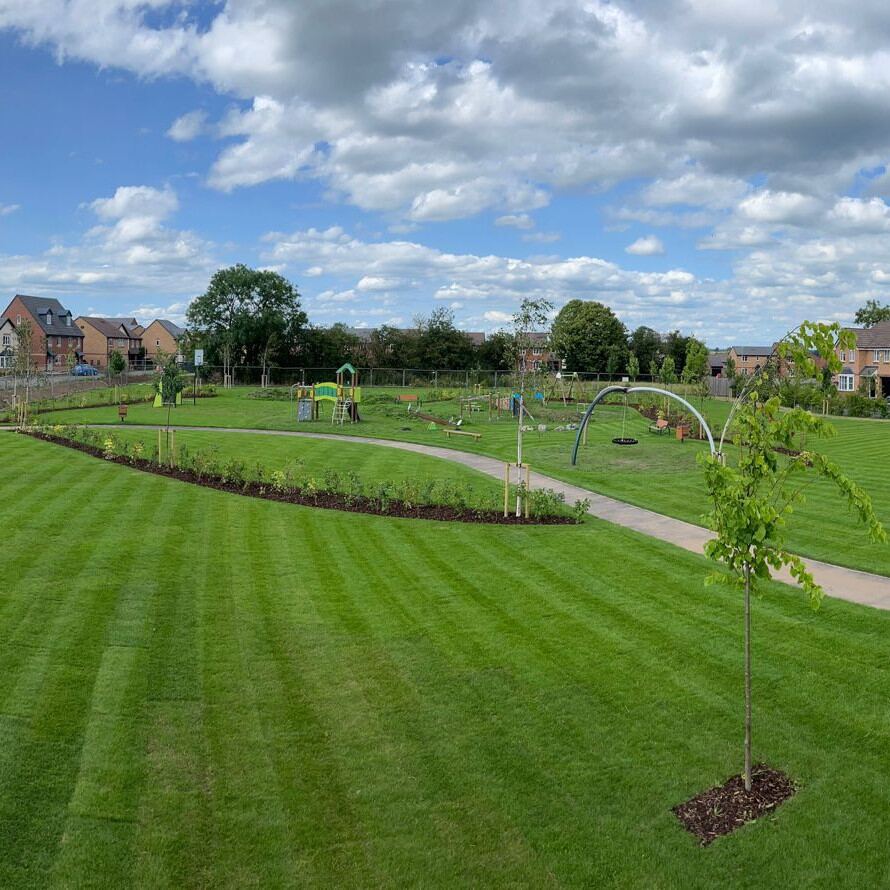 New striped lawn and play area at Beaconside, Stafford after Landywood landscaping