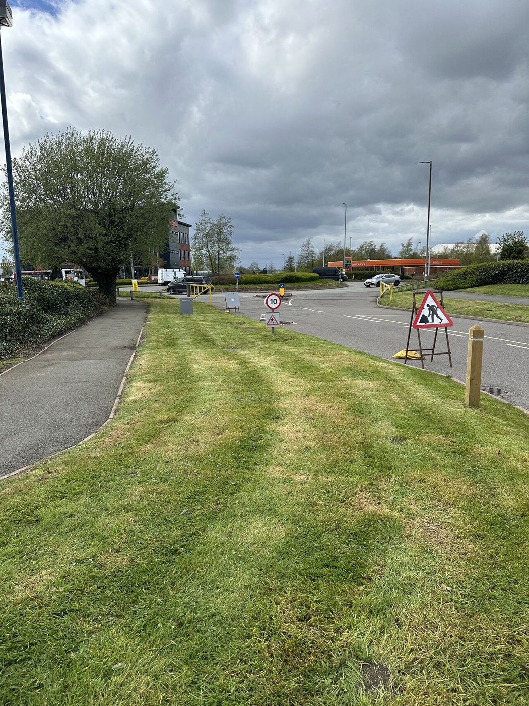 Cut grass beside the commercial site access road
