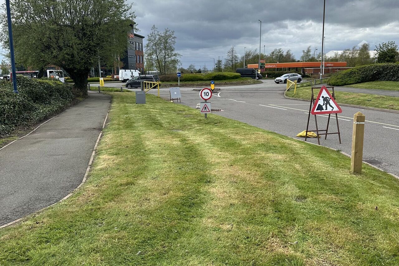 Freshly cut verge beside an access road at a Midlands retail park